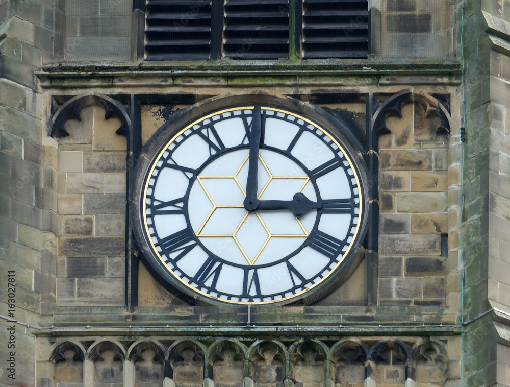 church clock white face with roman numerals at three o clock in the church in huddersfield church clock white face with roman numerals at three o clock in the church in huddersfield