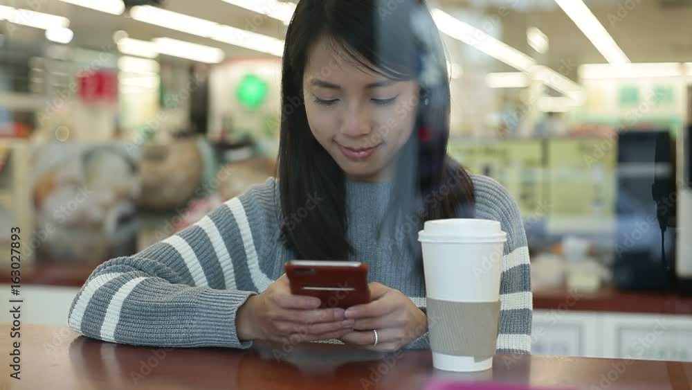 Woman enjoy her coffee using mobile phone at coffee shop Woman enjoy her coffee using mobile phone at coffee shop