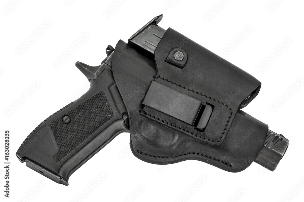 The gun in a tactical leather holster. Isolated The gun in a tactical leather holster. Isolated