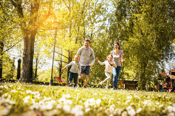 Cheerful family playing with their children's.