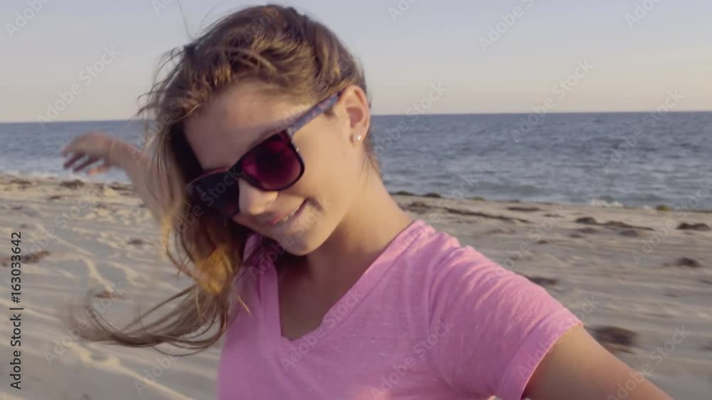 Carefree Teen, Arms Raised, Plays With Hair, Smiles In Back Of Moving Jeep, On Beach Carefree Teen, Arms Raised, Plays With Hair, Smiles In Back Of Moving Jeep, On Beach