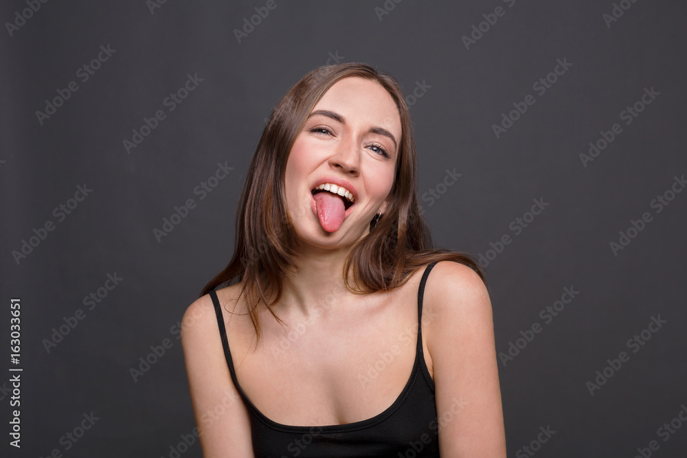 Beautiful modern girl shows tongue Beautiful modern girl shows tongue