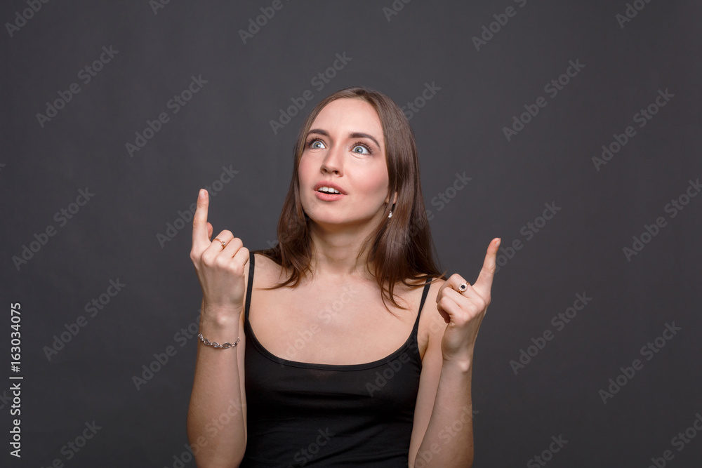 Shocked girl looking and pointing up Shocked girl looking and pointing up
