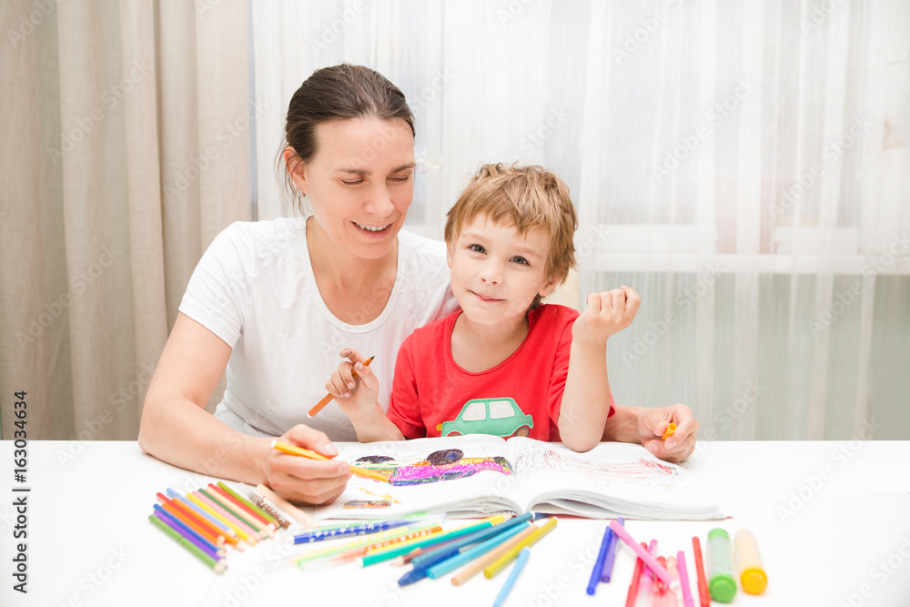 Fototapeta premium Happy family. Mother and little son together paint.