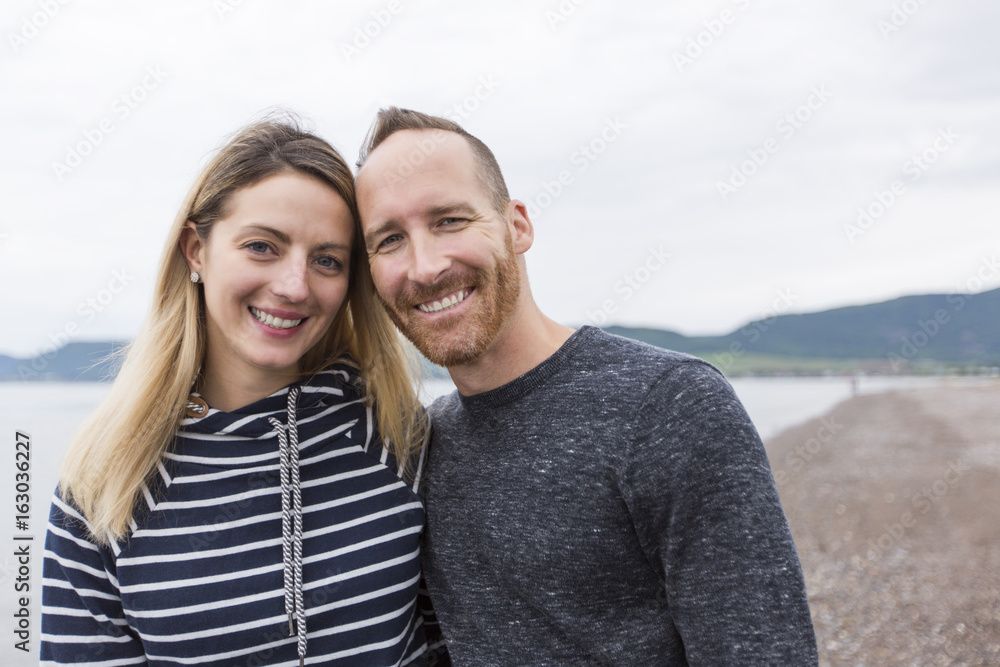 portrait of living young couple at the beach portrait of living young couple at the beach