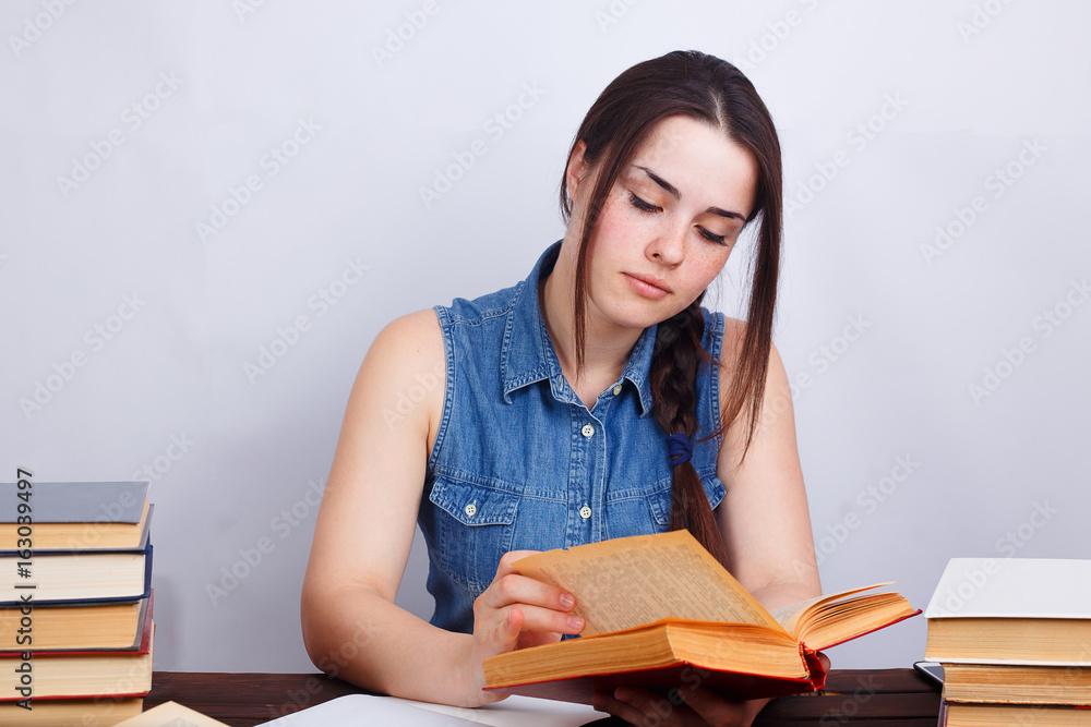 Portrait of young student girl reading a book Portrait of young student girl reading a book