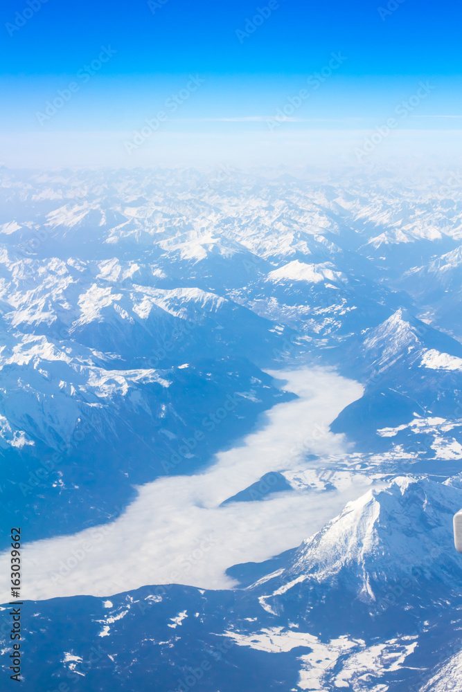 Fototapeta premium Snow Alps - aerial view from window of airplane