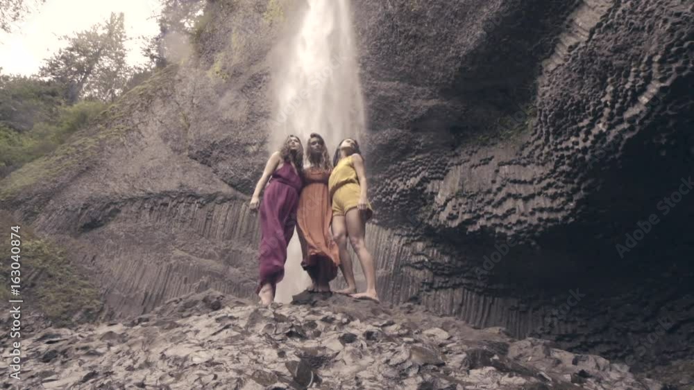 Models Pose On Rocks Below Epic Waterfall In Columbia River Gorge, Oregon (Slow Motion) Models Pose On Rocks Below Epic Waterfall In Columbia River Gorge, Oregon (Slow Motion)