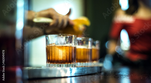 girl is whaiting a drink on the bar