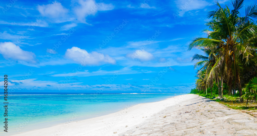 Panorama view of beautiful tropical beach with turquoise sea and blue sky Panorama view of beautiful tropical beach with turquoise sea and blue sky