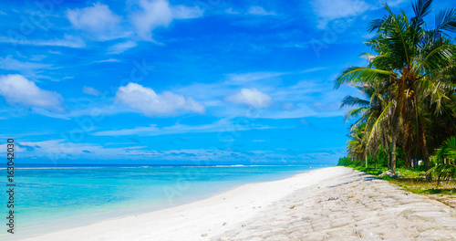 Panorama view of beautiful tropical beach with turquoise sea and blue sky