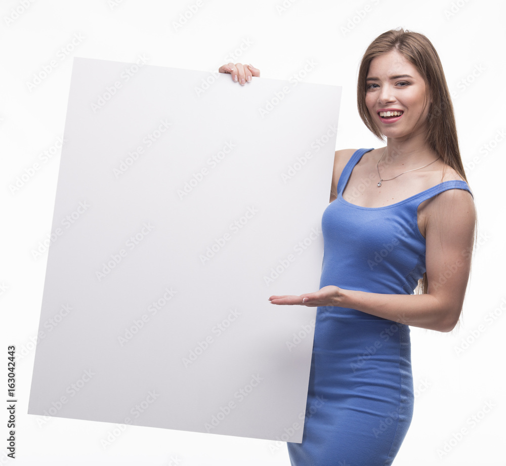 Young happy woman portrait of a confident businesswoman showing presentation, pointing paper placard gray background. Ideal for banners, registration forms, presentation, landings, presenting concept. Young happy woman portrait of a confident businesswoman showing presentation, pointing paper placard gray background. Ideal for banners, registration forms, presentation, landings, presenting concept.