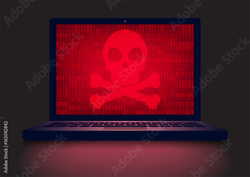 Laptop in a dark room with red skull and crossbones on glowing binary code screen background