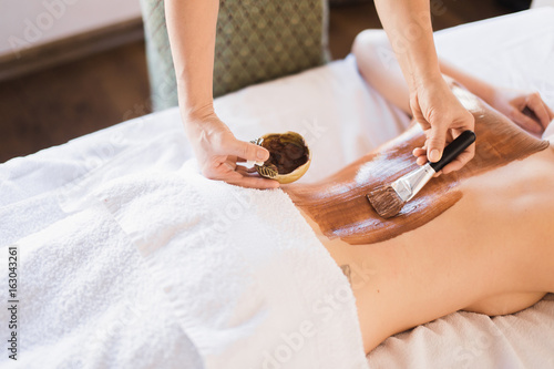 cacao therapy applied to young woman in a spa