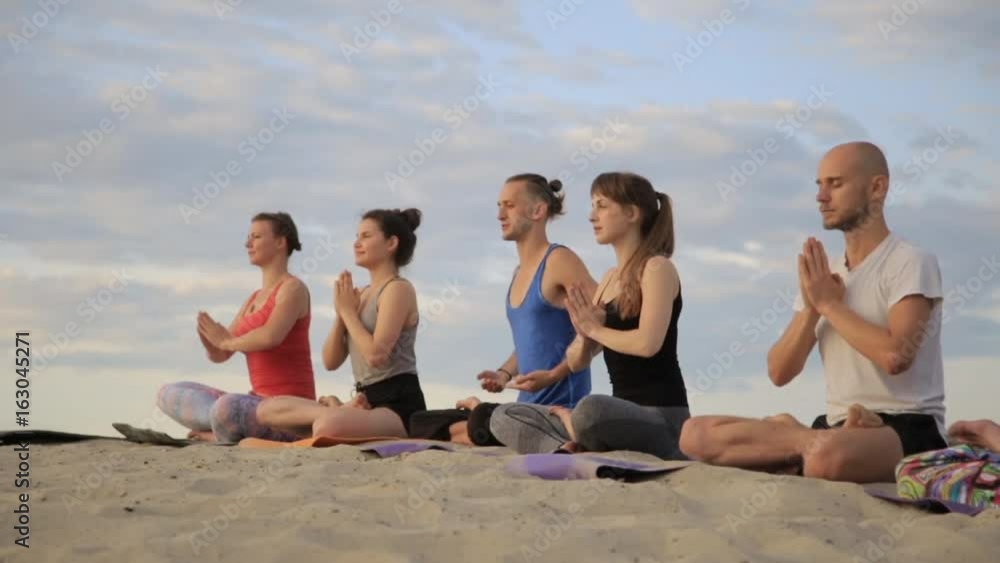 Mixed race group of people exercising yoga healthy lifestyle fitness warrior poses. Concentration. Mixed race group of people exercising yoga healthy lifestyle fitness warrior poses. Concentration.