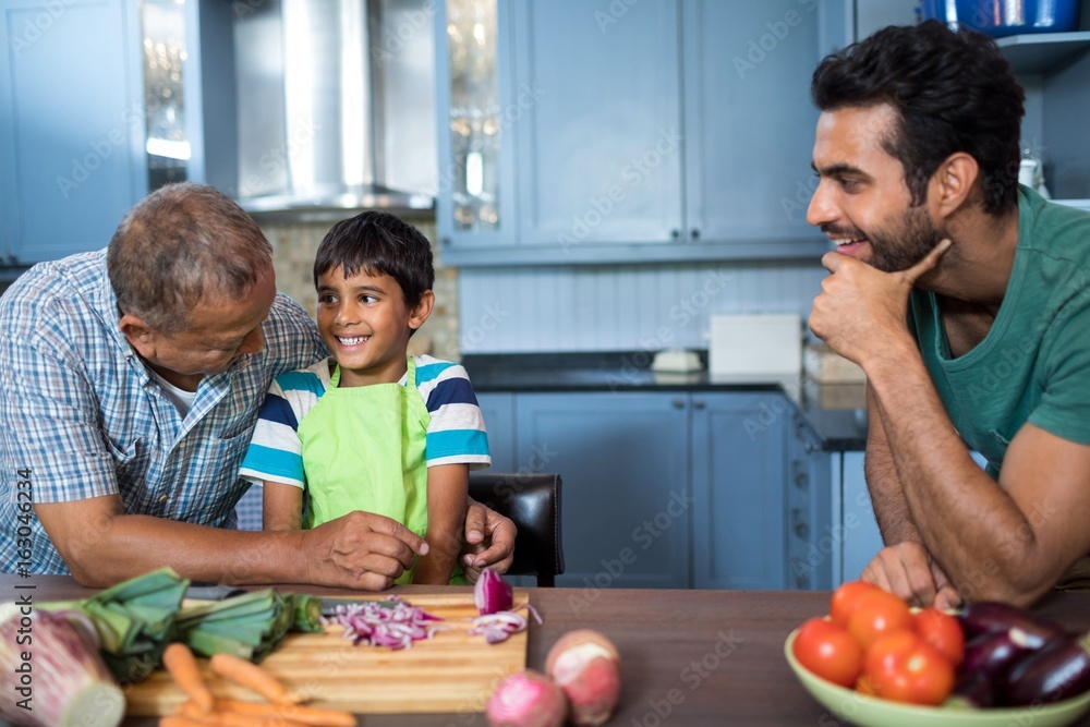 Man looking at happy boy and grandfather Man looking at happy boy and grandfather