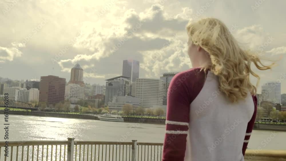 Young Woman On A Walk By The City Waterfront Park (Slow Motion) Young Woman On A Walk By The City Waterfront Park (Slow Motion)
