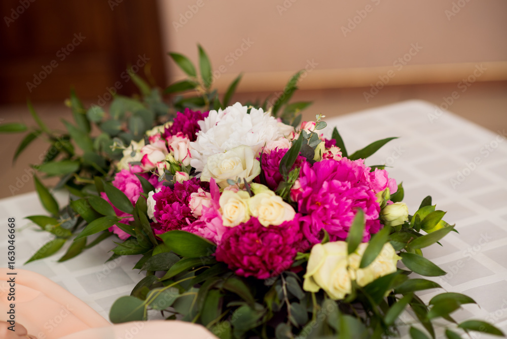 Wedding peony bouquet on table Wedding peony bouquet on table