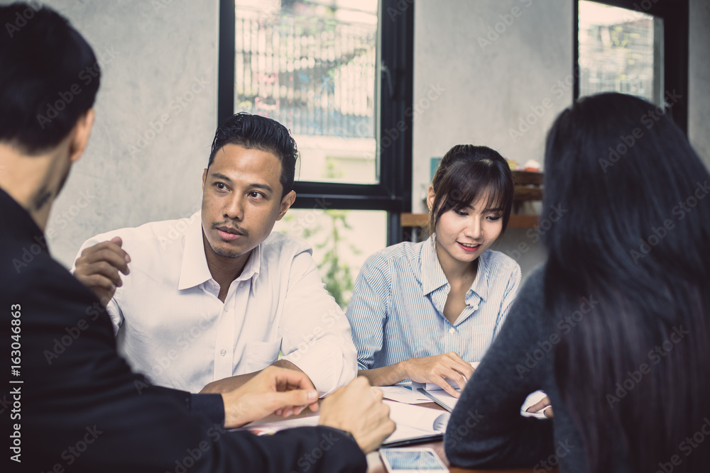 Businessman sitting for present the project with team, Portrait business leader concept, 20-30 year old, vintage tone Businessman sitting for present the project with team, Portrait business leader concept, 20-30 year old, vintage tone