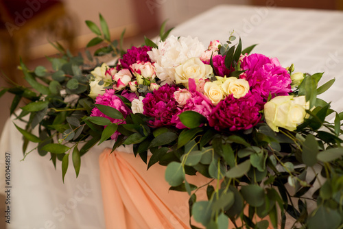Wedding peony bouquet on table © Aleksei Zakharov