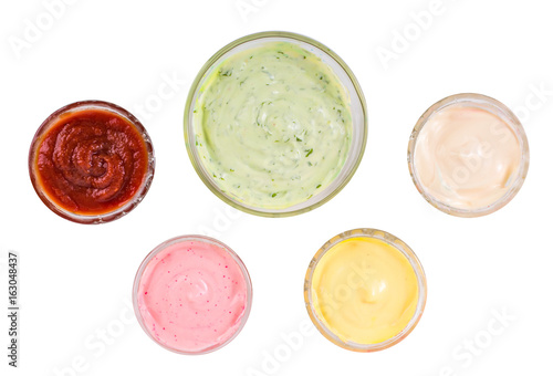 Different sauces over white background