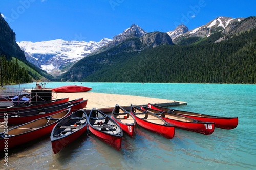 Red canoes in the blue waters of Lake Louise, Banff National Park, Alberta, Canada