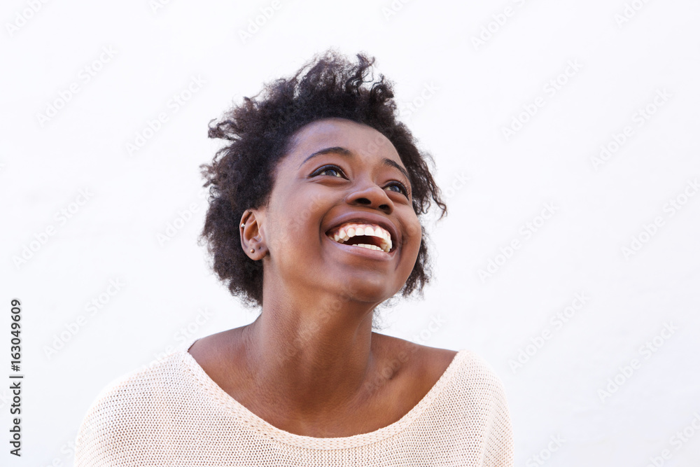 Young black woman looking up and laughing - obrazy, fototapety, plakaty 