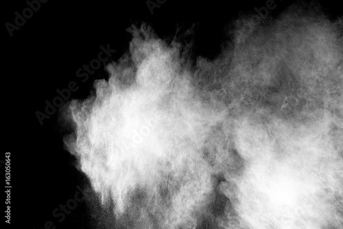 White color powder explosion on black background. Mauve white color cloud. Freeze motion painted Holi.