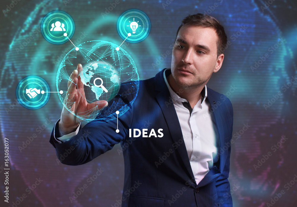 Business, Technology, Internet and network concept. Young businessman working on a virtual screen of the future and sees the inscription: Ideas Business, Technology, Internet and network concept. Young businessman working on a virtual screen of the future and sees the inscription: Ideas