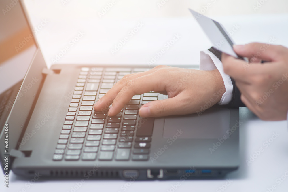 Business woman using laptop and using credit card for online shopping. Online shopping concept. Business woman using laptop and using credit card for online shopping. Online shopping concept.