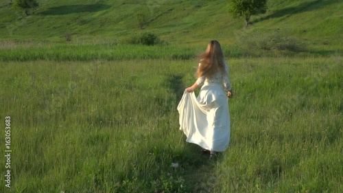 Beautiful woman running on the meadow slow motion