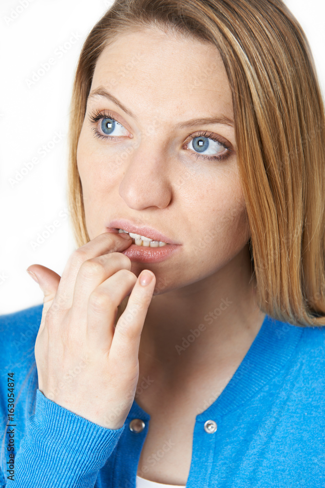 Studio Shot Of Nervous Woman Biting Nails Studio Shot Of Nervous Woman Biting Nails