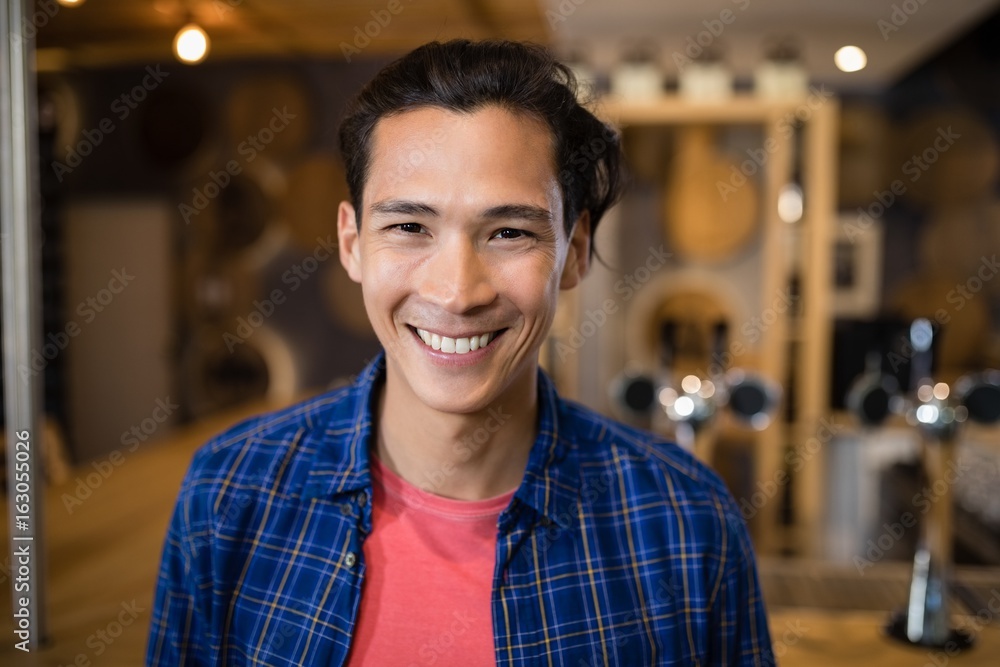 Smiling man standing near at counter Smiling man standing near at counter