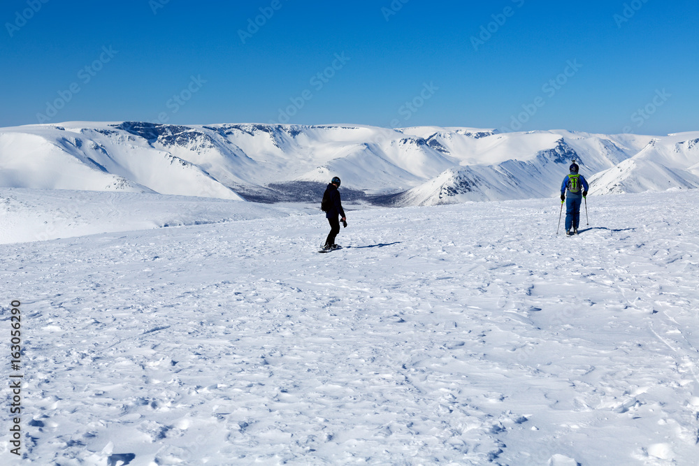 Two skiers on the top of the mountain