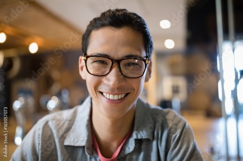 Smiling man sitting in bar