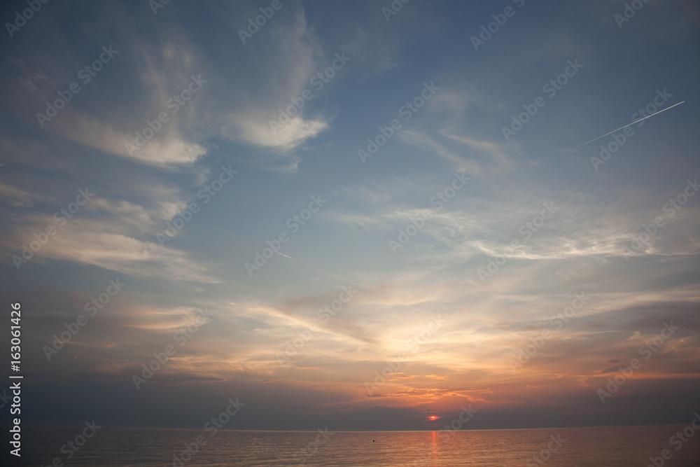 Sea scape scene in the Ocean, beach ocean sunset landscape. Bright Dramatic Sky And Dark Ground. Countryside Landscape Under Scenic Colorful Sky At Sunset Dawn Sunrise. Sun Over Skyline, Horizon. 