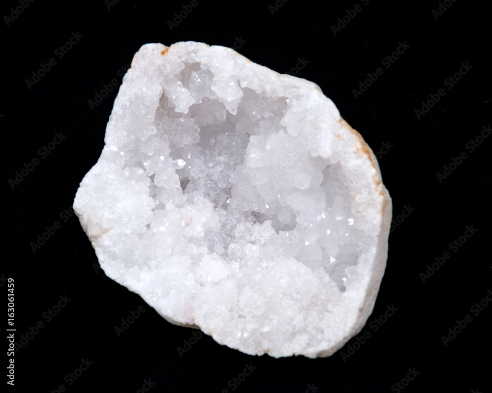 Clear crystal quartz geode with crystalline druzy center on black background Clear crystal quartz geode with crystalline druzy center on black background
