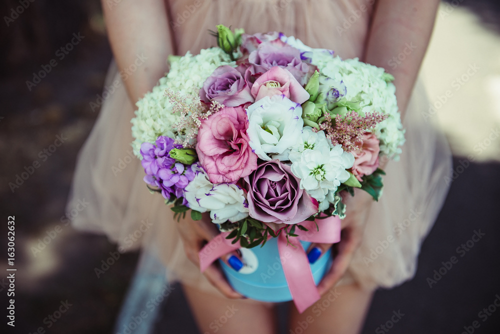 girl holding beautiful mix flower bouquet in round box girl holding beautiful mix flower bouquet in round box