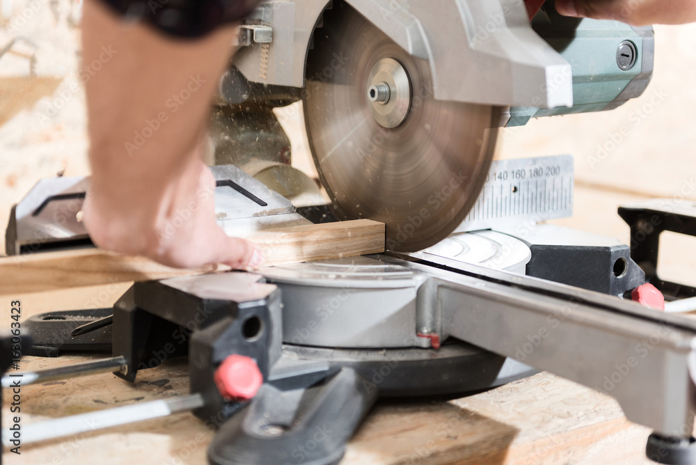 Woodworker is laboring on professional machine Woodworker is laboring on professional machine