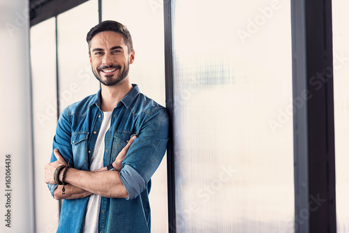 Cheerful smiling male person in room