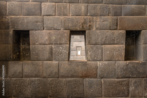 The three trapezoidal windows and Inca Wall of Rainbow Temple at Qoricancha Inca Ruins - Cusco, Peru photo