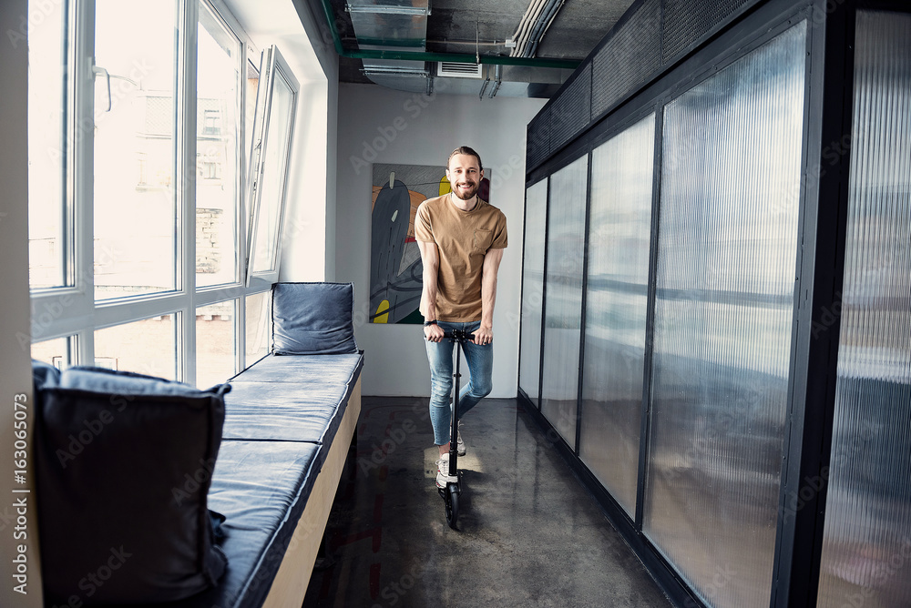 Happy smiling man using transport in office Happy smiling man using transport in office