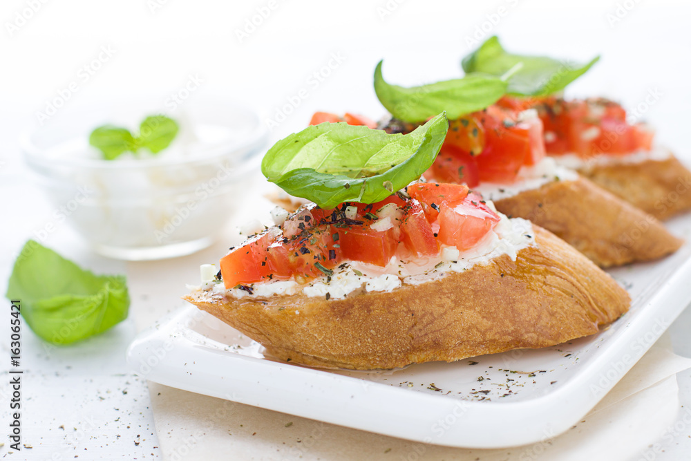 Bruschetta with cream cheese, tomatoes and basil Bruschetta with cream cheese, tomatoes and basil