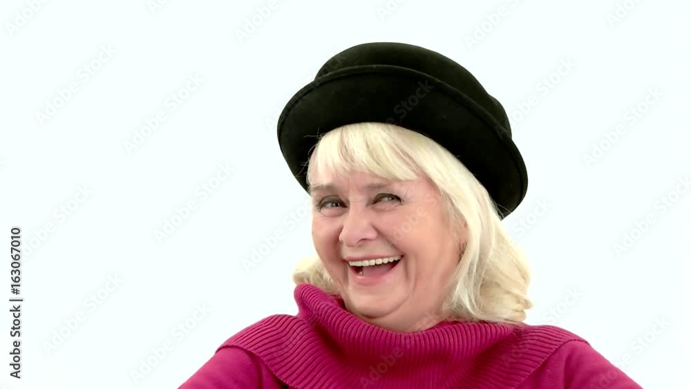 Senior woman laughing in slow-mo. Cheerful lady on white background. Laughter is the best medicine. Senior woman laughing in slow-mo. Cheerful lady on white background. Laughter is the best medicine.
