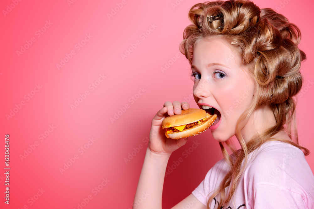girl eats hamburger