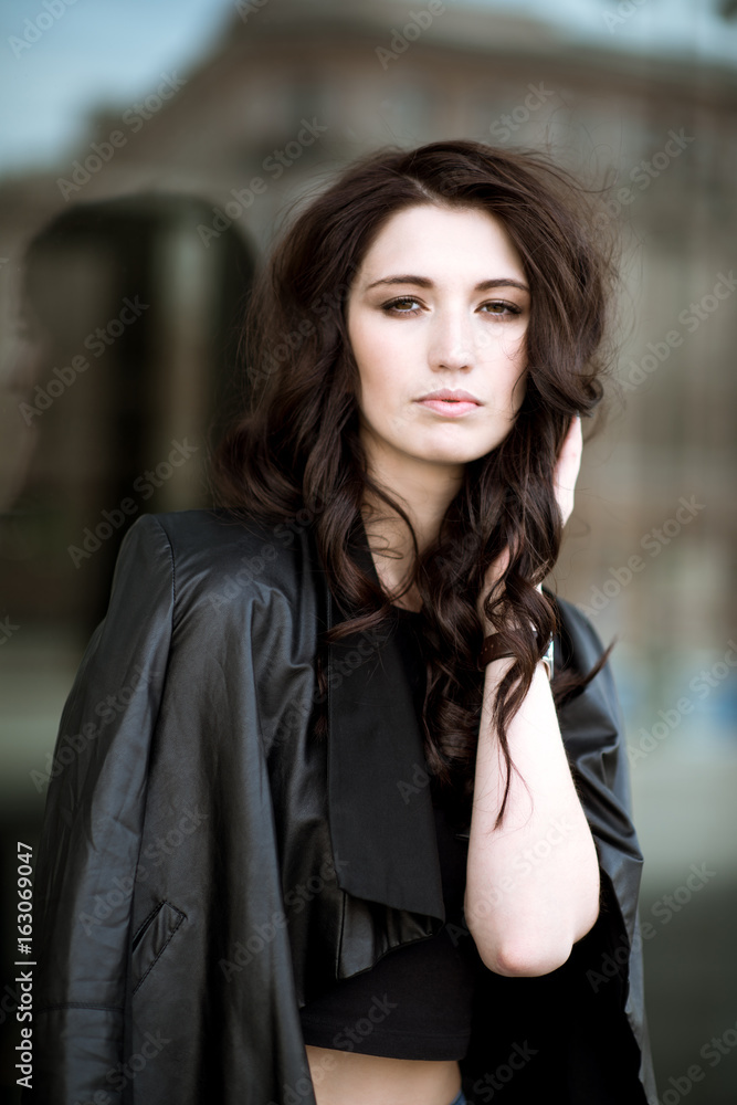 Fashionable portrait of lady with long hair in city