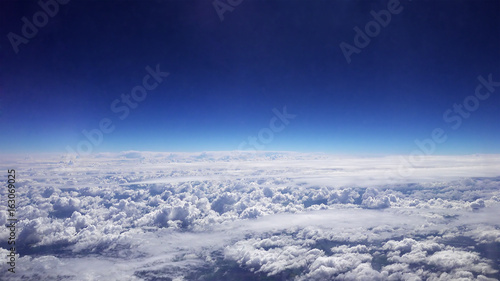 Flying over the clouds. Clouds and skyline horizon panoramic view. photo