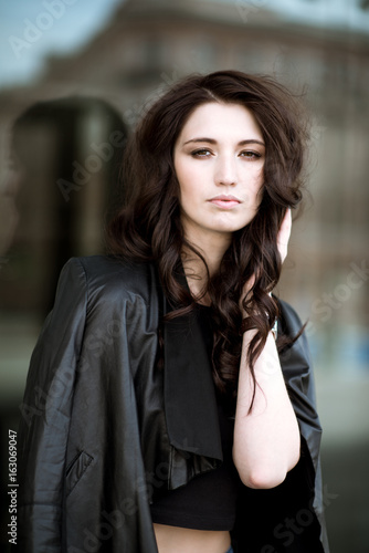 Fashionable portrait of lady with long hair in city © pvstory
