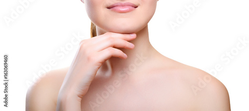 Portrait of girl with nude make-up with hands on chin isolated on white background. Girl with clean healthy skin on white. Cosmetology, medicine, beauty care. Nude makeup