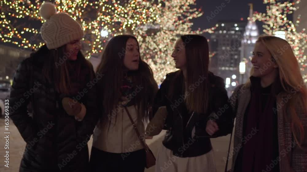 Slow Motion Shot Of Happy Friends Walking Arm In Arm In Downtown Salt Lake City, Utah, LDS Temple In Background Slow Motion Shot Of Happy Friends Walking Arm In Arm In Downtown Salt Lake City, Utah, LDS Temple In Background